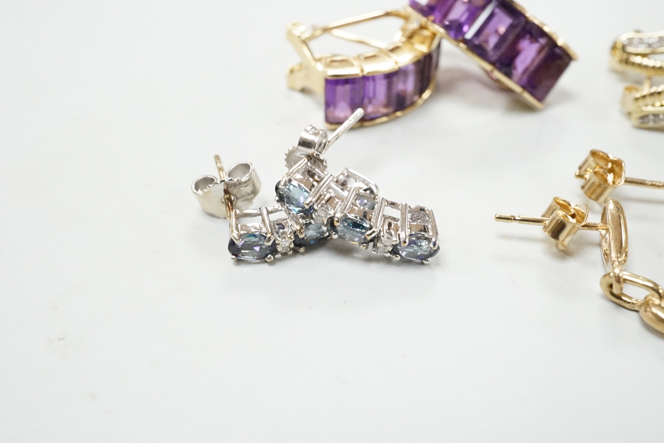 A modern pair of 585 yellow metal and five stone amethyst set demi lune earrings, 18mm, gross weight 6.2 grams, together with three modern pairs of 9ct and gem set earrings including two colour diamond cluster and one ot